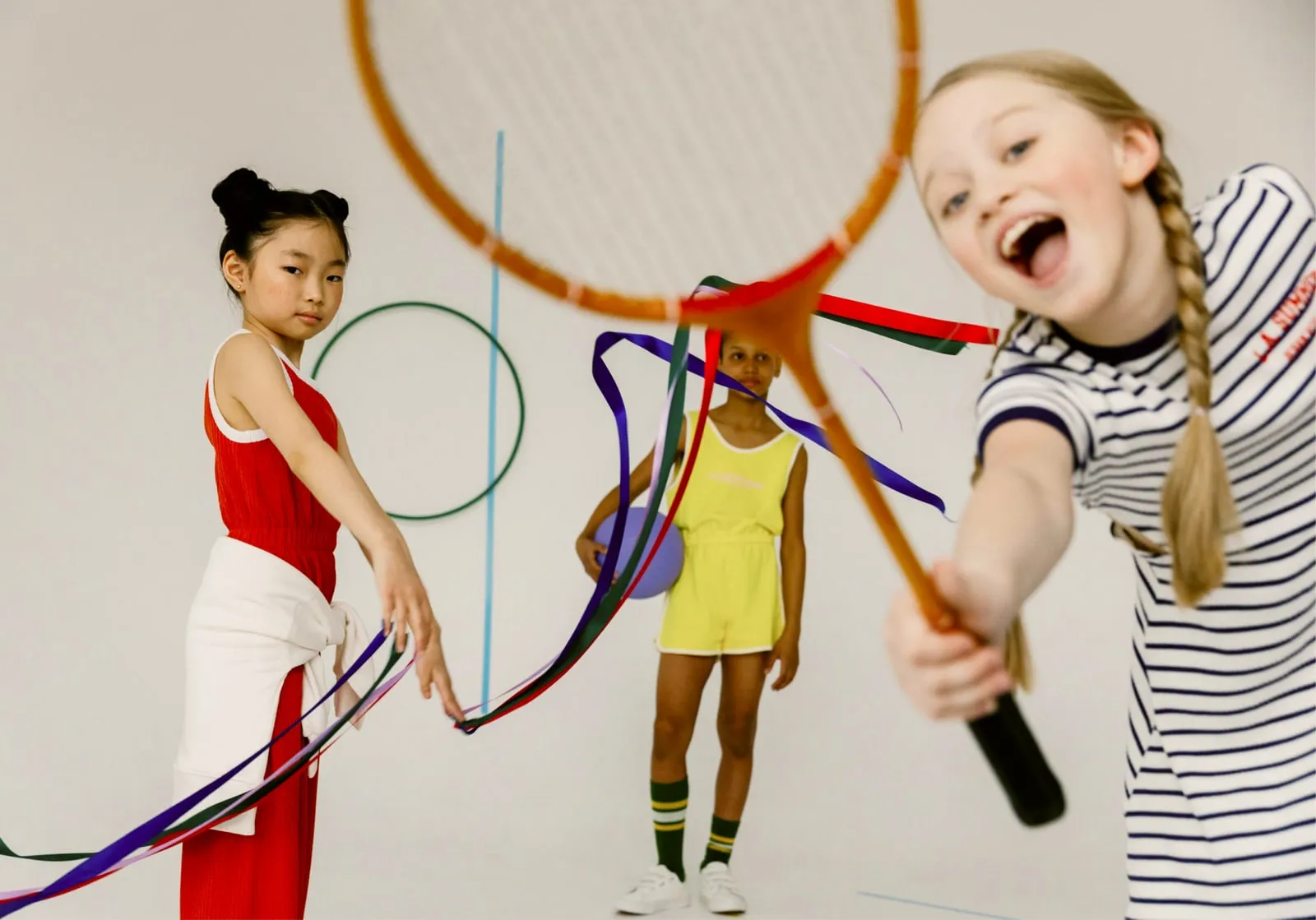 Children practicing rhythmic gymnastics with ribbons and hoops